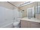Full bathroom features a shower-tub combo, tile floors and a large mirror above the vanity at 21532 N 65Th Ave, Glendale, AZ 85308