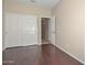 Spacious bedroom features hardwood floors, neutral walls and a closet with sliding doors at 21532 N 65Th Ave, Glendale, AZ 85308