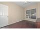 Bedroom with a window to let the sunlight in, neutral walls and hardwood floors at 21532 N 65Th Ave, Glendale, AZ 85308