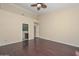 A bedroom has a fan and a lot of natural light from the many windows and wood floors at 21532 N 65Th Ave, Glendale, AZ 85308