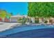 Charming single-story home with a tile roof, mature landscaping, and a well-manicured front yard at 21532 N 65Th Ave, Glendale, AZ 85308