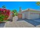 Home with a charming gated entrance, meticulously maintained landscaping, and a spacious two-car garage at 21532 N 65Th Ave, Glendale, AZ 85308