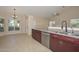 A spacious kitchen features stainless steel appliances, granite countertops, and tile flooring at 21532 N 65Th Ave, Glendale, AZ 85308