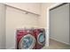 Laundry room features side-by-side washer and dryer, tile floor, and storage cabinets at 21532 N 65Th Ave, Glendale, AZ 85308