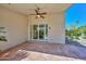 Covered patio with a ceiling fan overlooking the landscaped yard at 21532 N 65Th Ave, Glendale, AZ 85308