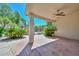 Covered outdoor patio featuring decorative concrete, ceiling fan, and lush landscaping at 21532 N 65Th Ave, Glendale, AZ 85308