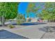 Street view of a well-maintained house with mature landscaping and a circular driveway at 21532 N 65Th Ave, Glendale, AZ 85308