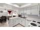 Bright kitchen with white cabinets, countertops, and appliances, open to the dining area at 220 N 22Nd Pl # 2029, Mesa, AZ 85213
