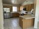 Well-equipped kitchen featuring wood cabinets, stainless steel appliances, and tiled flooring at 2221 E Union Hills Dr # 157, Phoenix, AZ 85024