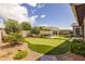 Serene backyard features a putting green, a pergola with outdoor seating, and lush landscaping at 22670 E Russet Rd, Queen Creek, AZ 85142