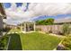 Well-maintained backyard features manicured landscaping, artificial turf, and a covered patio area at 22670 E Russet Rd, Queen Creek, AZ 85142