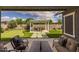 Inviting patio area with comfortable seating overlooks the backyard's manicured lawn and lush landscaping at 22670 E Russet Rd, Queen Creek, AZ 85142