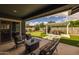 Relaxing outdoor space featuring a patio, putting green, and a pergola with dining table at 22670 E Russet Rd, Queen Creek, AZ 85142