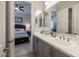 Bathroom featuring double sinks, granite countertops, and framed mirrors, with a bedroom view at 22670 E Russet Rd, Queen Creek, AZ 85142