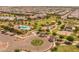 Birds-eye view of a vibrant community park with playgrounds, picnic areas, and a swimming pool at 22670 E Russet Rd, Queen Creek, AZ 85142