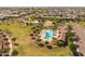Aerial view of a community pool featuring palm trees, ample seating, and well-maintained landscaping at 22670 E Russet Rd, Queen Creek, AZ 85142