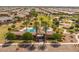 Aerial shot of a community pool area showcasing the entrance, landscaping, and surrounding neighborhood at 22670 E Russet Rd, Queen Creek, AZ 85142