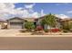 Charming single-story home features a well-manicured front yard, mature trees, and a spacious garage at 22670 E Russet Rd, Queen Creek, AZ 85142