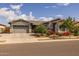 Beautiful single-story home featuring manicured landscaping, gray stucco, and a two-car garage at 22670 E Russet Rd, Queen Creek, AZ 85142