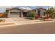 Attractive one-story home featuring a gray stucco exterior, a two-car garage, and a beautifully landscaped yard at 22670 E Russet Rd, Queen Creek, AZ 85142
