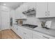 Modern kitchen features stainless steel appliances, quartz countertops, and white cabinets at 22670 E Russet Rd, Queen Creek, AZ 85142