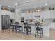 Modern kitchen with white cabinetry, quartz countertops, stainless steel appliances, and large island with seating at 22670 E Russet Rd, Queen Creek, AZ 85142