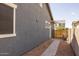 Side yard features hardscape and landscape, with a paved walkway and secure fencing at 22670 E Russet Rd, Queen Creek, AZ 85142