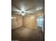 Bedroom with neutral paint, carpeted floors, ceiling fan, and open bathroom doorway at 2328 W Lupine Ave, Phoenix, AZ 85029
