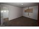 Bedroom featuring white walls, carpeted floors, a closet, and a doorway to a bathroom at 2328 W Lupine Ave, Phoenix, AZ 85029
