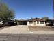 Single-story home with a covered carport, neutral color palette, and a large front yard at 2328 W Lupine Ave, Phoenix, AZ 85029