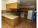 Functional kitchen with tiled floor, countertops, wooden cabinetry, and appliances at 2328 W Lupine Ave, Phoenix, AZ 85029