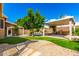 Serene backyard with lush lawn, custom pergola, built-in BBQ, and charming rock waterfall pool feature at 23829 N 59Th Dr, Glendale, AZ 85310