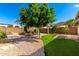 Expansive backyard featuring a pool, built-in grill, lush lawn, and desert landscaping at 23829 N 59Th Dr, Glendale, AZ 85310