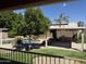 Beautiful backyard featuring a sparkling pool, lush landscaping, and a built-in outdoor kitchen with a grill at 23829 N 59Th Dr, Glendale, AZ 85310