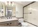 Well-lit bathroom featuring a granite vanity and shower-tub combination at 23829 N 59Th Dr, Glendale, AZ 85310