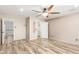 Bedroom featuring a ceiling fan, wood-look floors, and an open closet space at 23829 N 59Th Dr, Glendale, AZ 85310