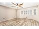 Well-lit bedroom with neutral walls, wood-look flooring and a bay window at 23829 N 59Th Dr, Glendale, AZ 85310