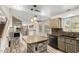 Open kitchen boasts granite counters, central island, and pendant lighting at 23829 N 59Th Dr, Glendale, AZ 85310