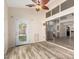 Bright room featuring hardwood floors, ceiling fan, and large glass doors to the backyard at 23829 N 59Th Dr, Glendale, AZ 85310