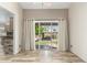Living room with neutral walls, light wood flooring, and sliding glass doors leading to backyard at 23829 N 59Th Dr, Glendale, AZ 85310