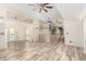 Spacious open-concept living room with high ceilings, wood floors, and a clear view of the kitchen at 23829 N 59Th Dr, Glendale, AZ 85310