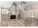 Open living room with high ceilings, built-in shelving, and a fireplace; bathed in natural light at 23829 N 59Th Dr, Glendale, AZ 85310