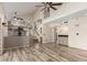 Spacious open-concept living area with wood floors, high ceilings, and seamless flow to the kitchen at 23829 N 59Th Dr, Glendale, AZ 85310