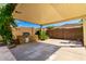 Outdoor kitchen area with a built-in grill, stone accents, and shaded patio at 23829 N 59Th Dr, Glendale, AZ 85310