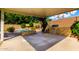 Covered patio showcasing a built-in stone grill and barbecue area next to the pool at 23829 N 59Th Dr, Glendale, AZ 85310