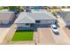 Aerial view of the property showcasing the well-maintained lawn, updated roof, and convenient driveway at 2410 N 40Th St, Phoenix, AZ 85008