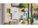 Aerial view showcasing the backyard with a pool, patio area, lush greenery, and surrounding neighborhood at 2410 N 40Th St, Phoenix, AZ 85008