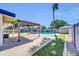 Beautiful backyard showcasing a refreshing pool, covered patio, and vibrant mural for outdoor relaxation and entertainment at 2410 N 40Th St, Phoenix, AZ 85008