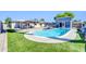 Backyard with a pool, gazebo, blue shed and artificial turf at 2410 N 40Th St, Phoenix, AZ 85008