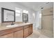 Bathroom showcasing double vanity with granite countertops and glass shower at 2410 N 40Th St, Phoenix, AZ 85008